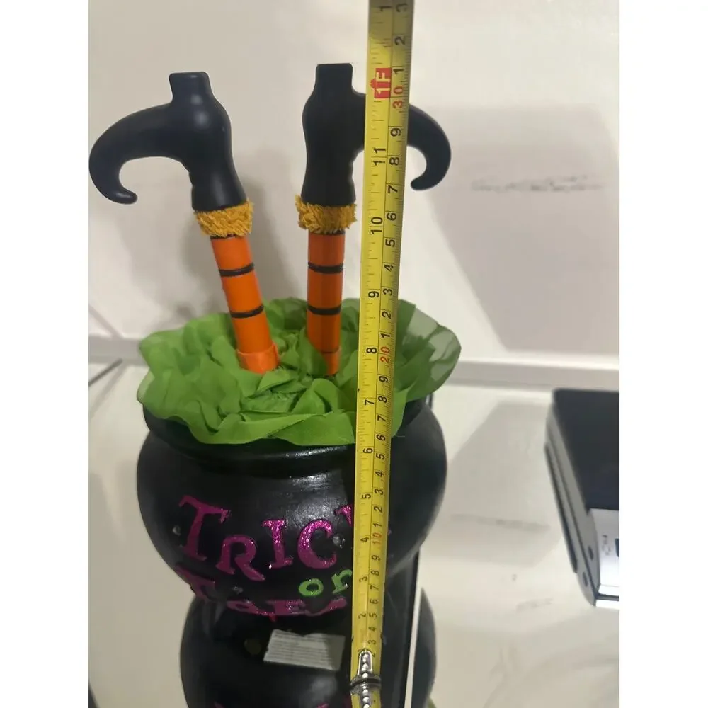 Halloween witch leg cauldron w/black pot labeled 